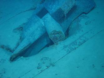 Stbd anchor embedded in steel plate from ship's side in debris field